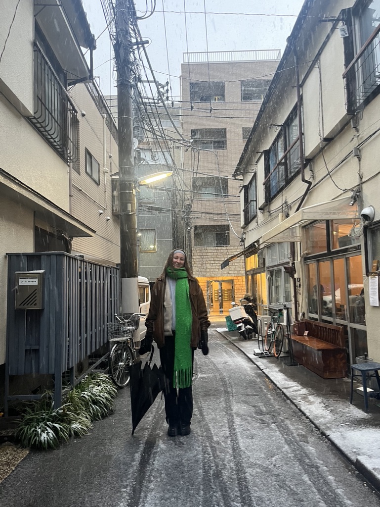 girl standing in front of a shinjuku cafe in the snow