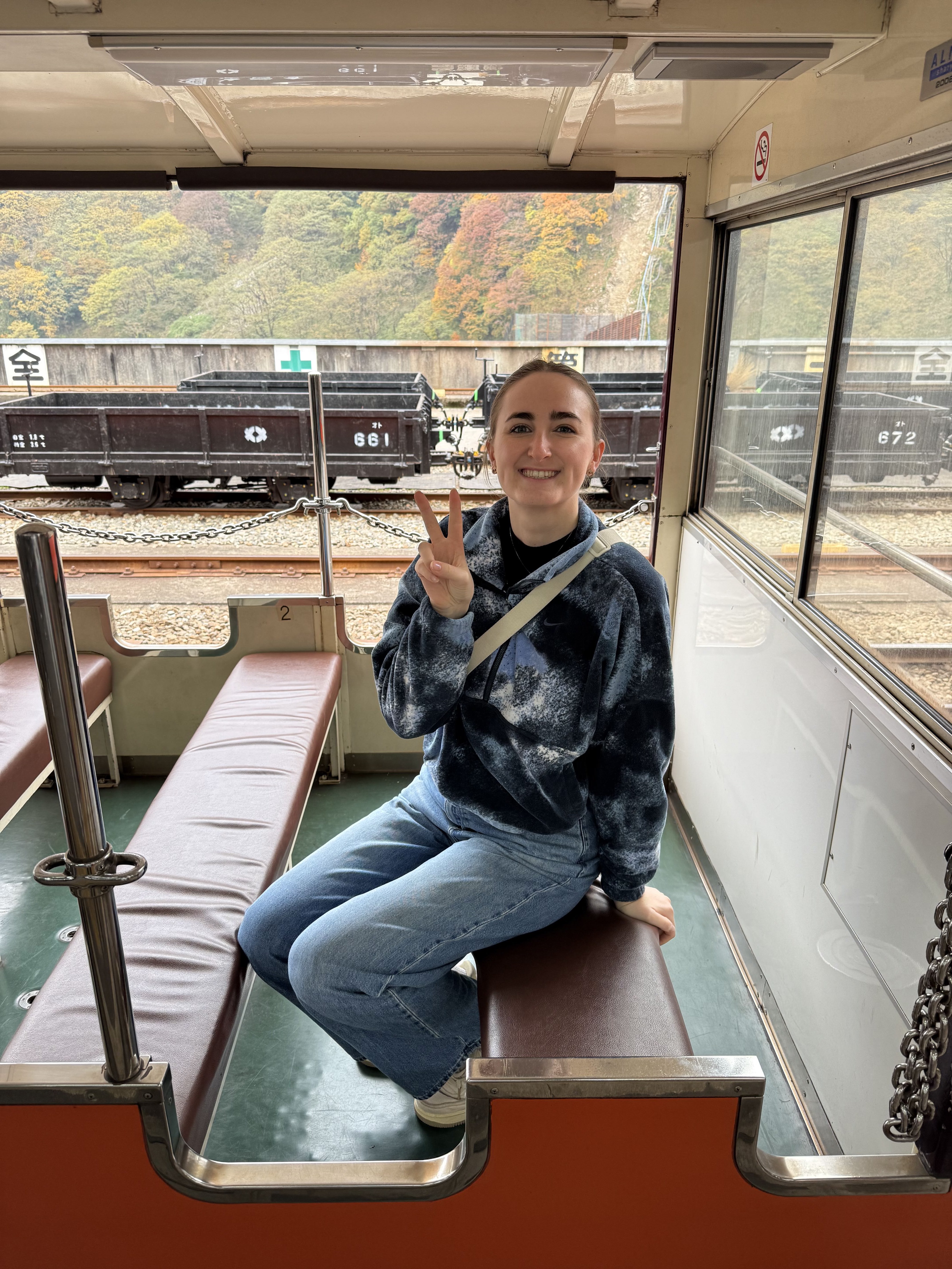Girl sitting on the scenic train in Kurobe Gorge