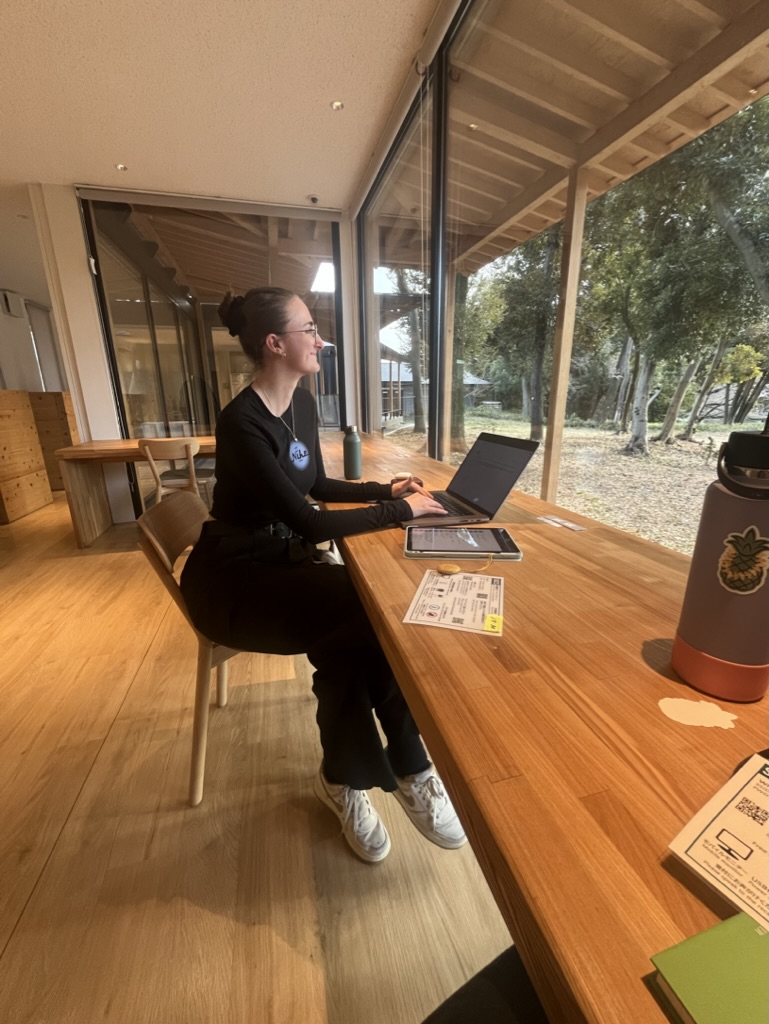 Girl working inside the wooden interior design of shinjuku gyoen coworking space