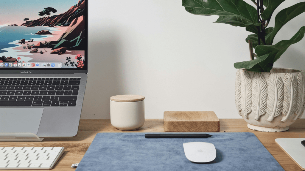 photo of desk tools for remote work with laptop stand, bluetooth mouse, and wireless keyboard