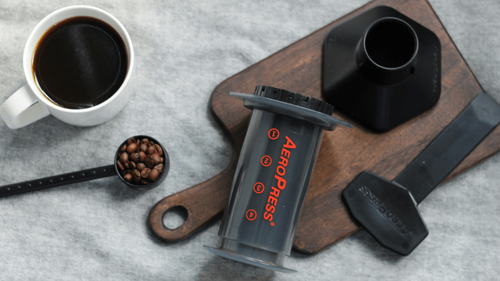 Photo of an aeropress and cup of coffee as a travel tool for remote work